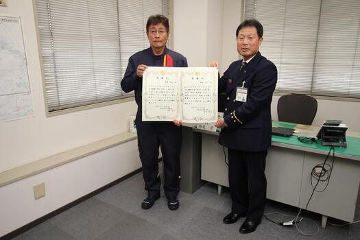 当日欠席の志摩様、森本様の代理で表彰された猪熊(いのくま)様と北消防署長の写真